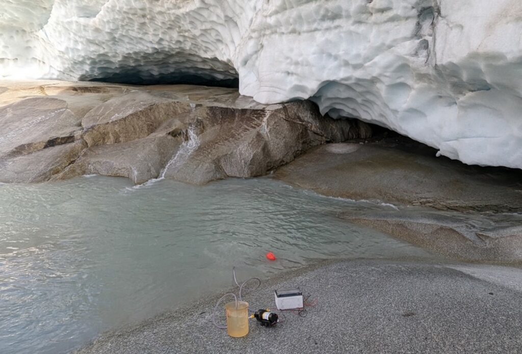 Subglacial water exiting the glacial toe of the Rhone Glacier. The water looks milky due to the presence of glacial flour.